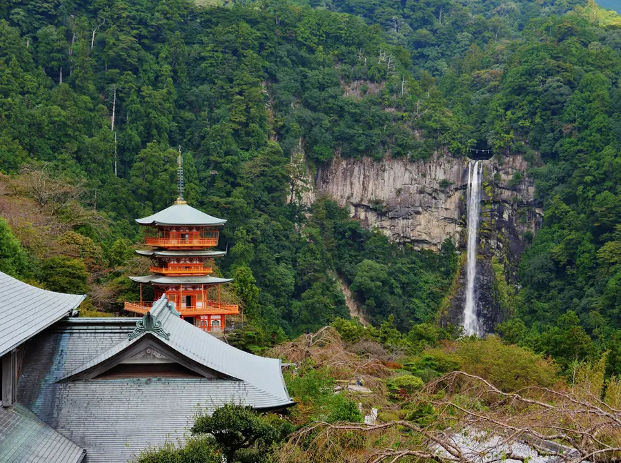 The vermilion three-storey pagoda of Seiganto-ji with Nachi Falls behind it